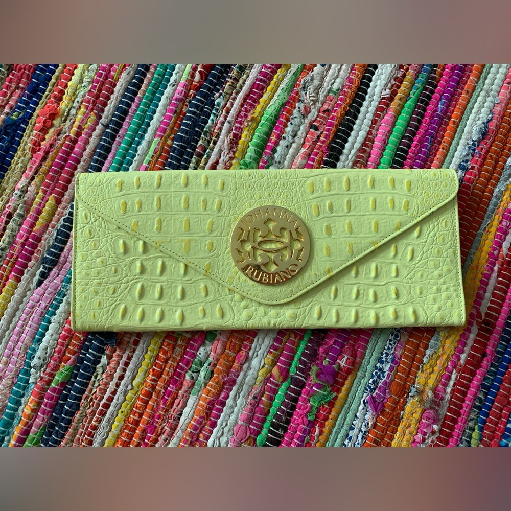Johanna Rubiano Alligator clutch.Yellow outside blue suede inside. Gold emblem.